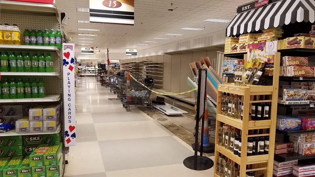 A grocery store aisle with packaged goods stocked on shelves